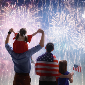 Family watching a Fourth of July fireworks display in California